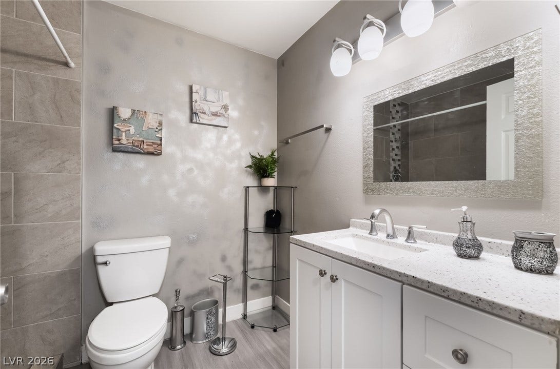 3111 Belvedere Drive, Henderson, NV 89014 A well-appointed bathroom with a modern vanity and light fixtures for a refreshing start to your day.