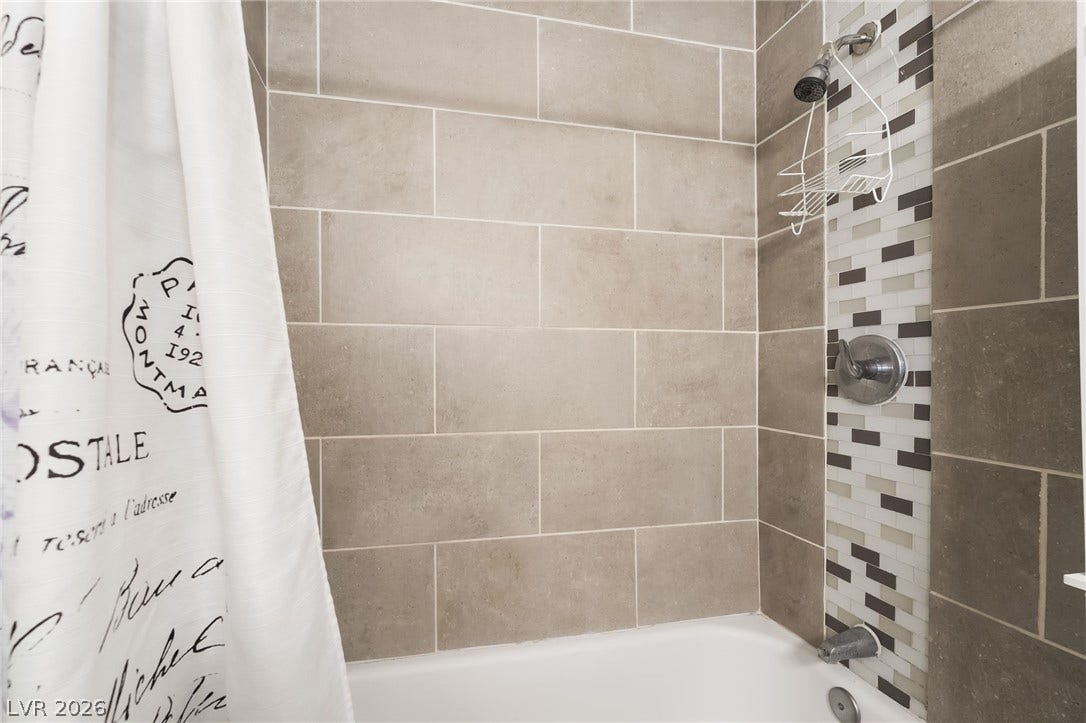 3111 Belvedere Drive, Henderson, NV 89014 A well-appointed bath features a tiled shower with contrasting accent mosaic.