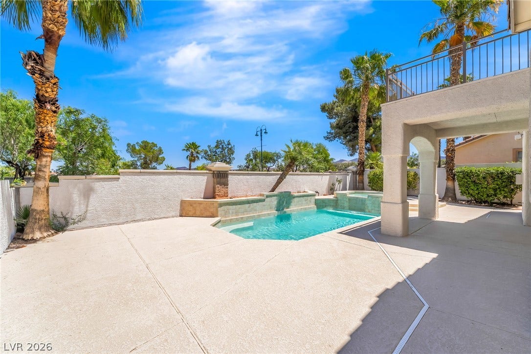 1278 Autumn Wind Way, Henderson, NV 89052 An inviting backyard oasis offers a crystal-clear pool and spa, perfect for relaxation and outdoor enjoyment.