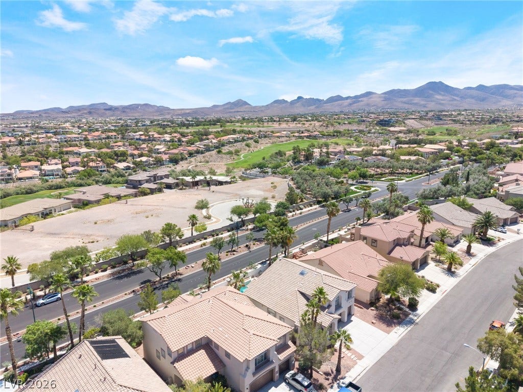1278 Autumn Wind Way, Henderson, NV 89052 An aerial perspective reveals a serene community nestled against a majestic mountain backdrop with a golf course nearby.