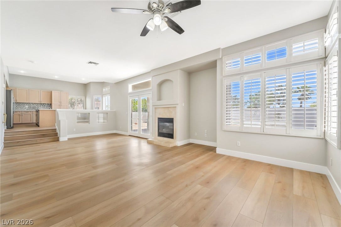1278 Autumn Wind Way, Henderson, NV 89052 Blonde hardwood floors extend across this naturally illuminated living space, featuring an inviting fireplace and backyard access.