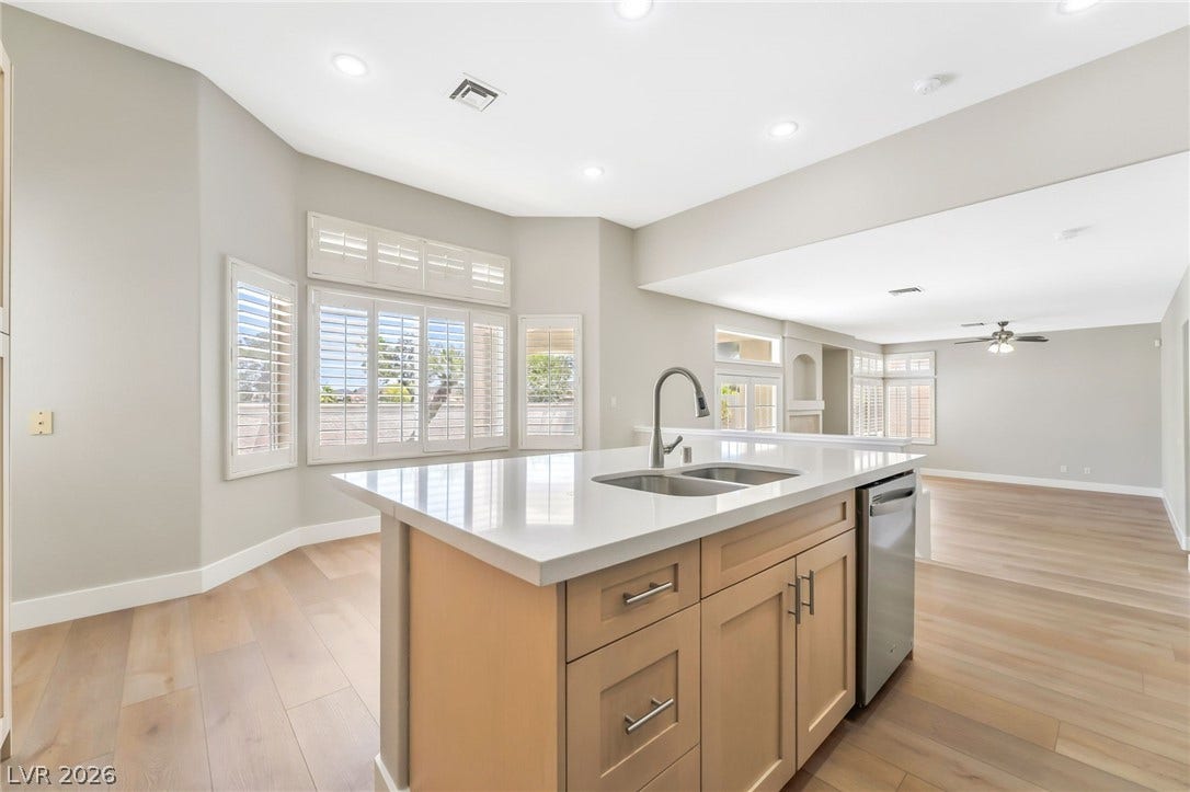 1278 Autumn Wind Way, Henderson, NV 89052 A central island anchors this bright kitchen, complete with light wood flooring.