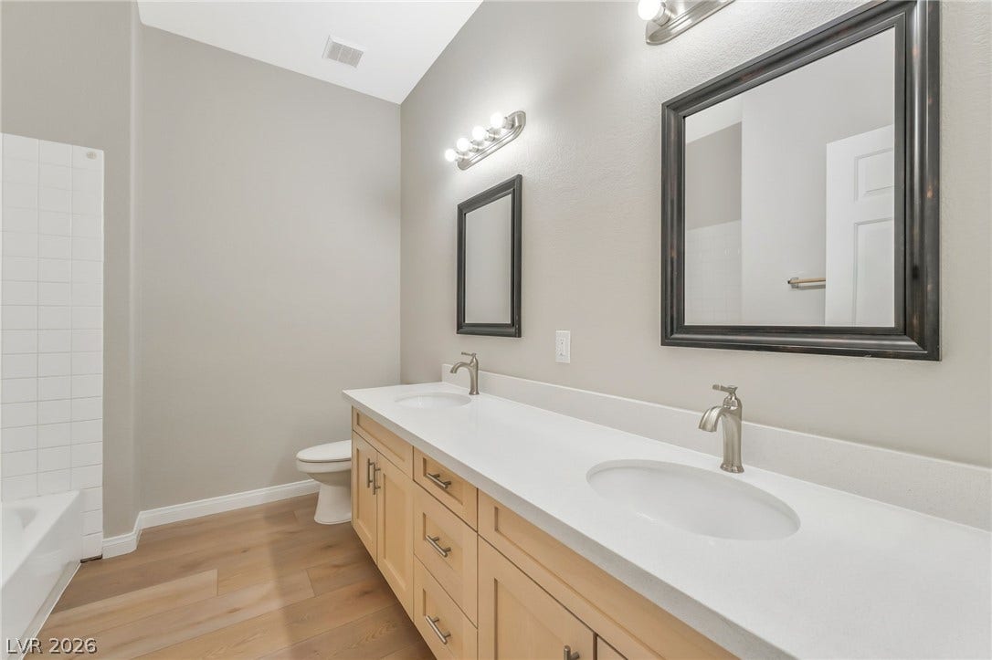 1278 Autumn Wind Way, Henderson, NV 89052 A well-appointed bathroom features a double vanity with ample counter space and individual mirrors.
