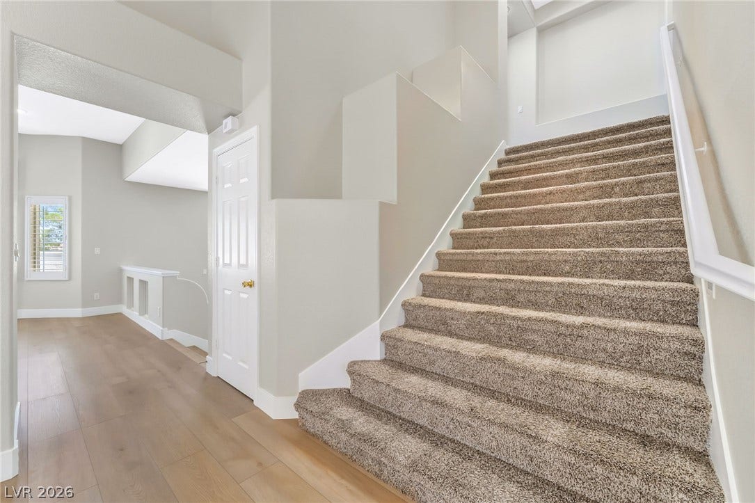 1278 Autumn Wind Way, Henderson, NV 89052 A well-lit entryway features rich wood flooring and a staircase leading to the upper level.