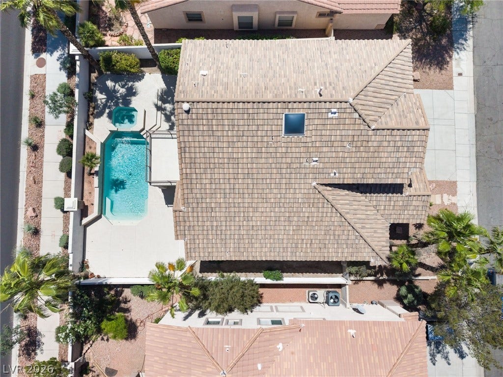 1278 Autumn Wind Way, Henderson, NV 89052 An aerial perspective reveals a private swimming pool nestled beside a home with a tiled roof.