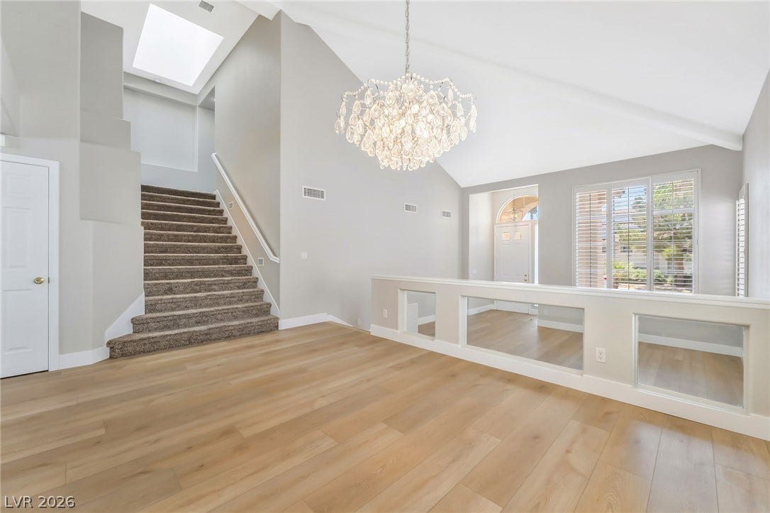 1278 Autumn Wind Way, Henderson, NV 89052 A grand crystal chandelier illuminates an airy entry with high ceilings and light wood floors.