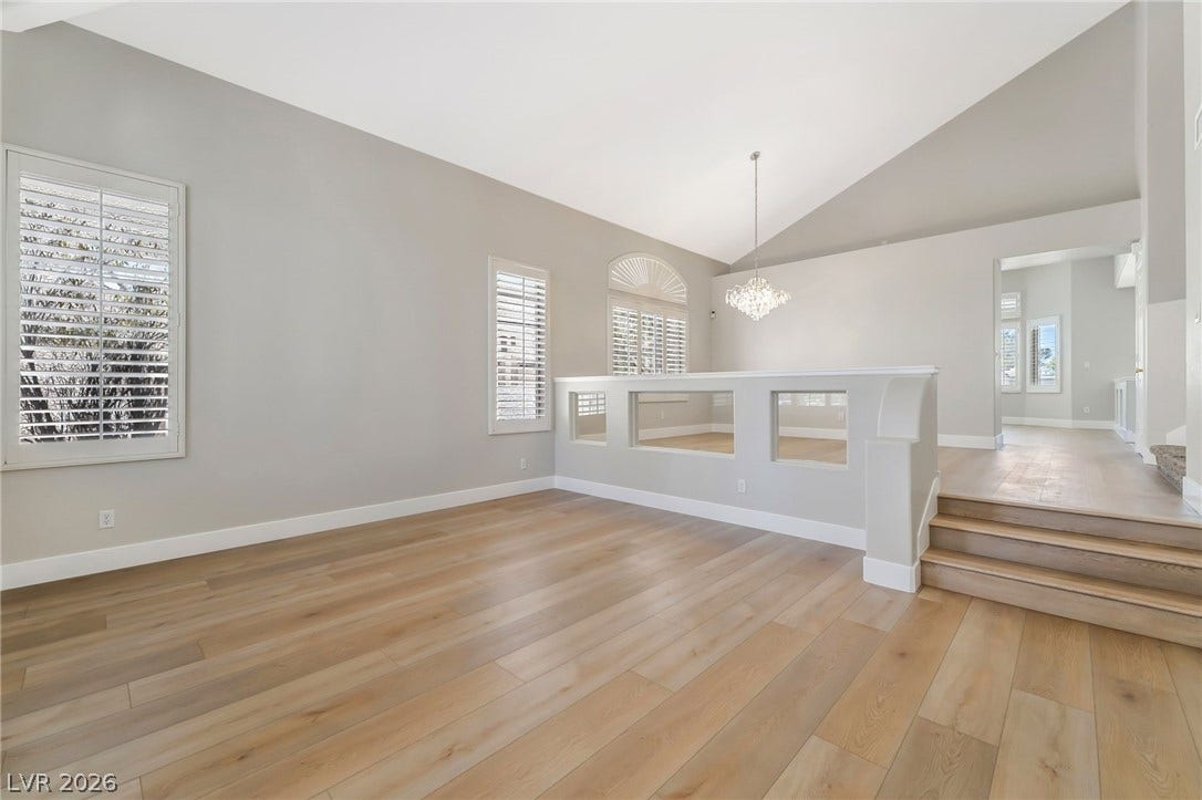 1278 Autumn Wind Way, Henderson, NV 89052 A graceful chandelier illuminates the soaring vaulted ceiling, highlighting the inviting hardwood floors and sun-filled windows.