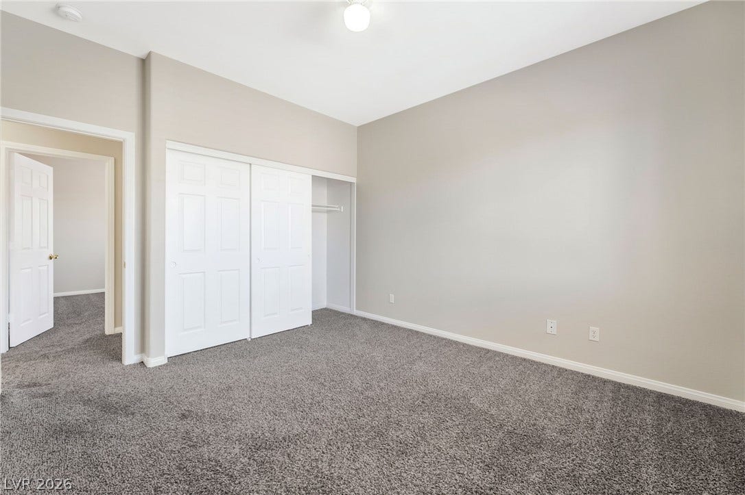 1278 Autumn Wind Way, Henderson, NV 89052 A spacious bedroom offers ample storage with bi-fold closet doors and plush carpeting underfoot.