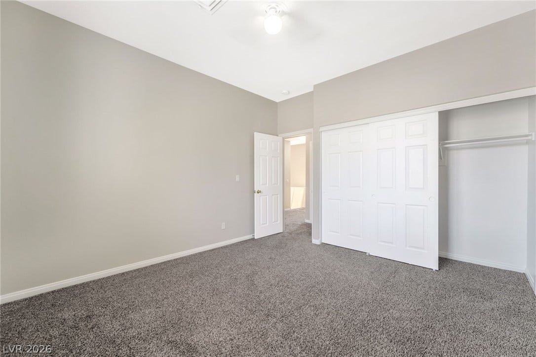 1278 Autumn Wind Way, Henderson, NV 89052 A well-lit bedroom features plush carpeting and convenient closet space, offering a comfortable retreat.