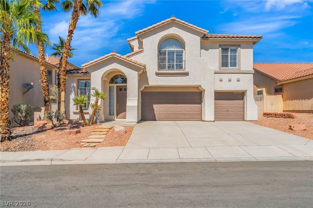 1278 Autumn Wind Way, Henderson, NV 89052 A graceful facade with arched entry and tiled roof provides desert curb appeal.