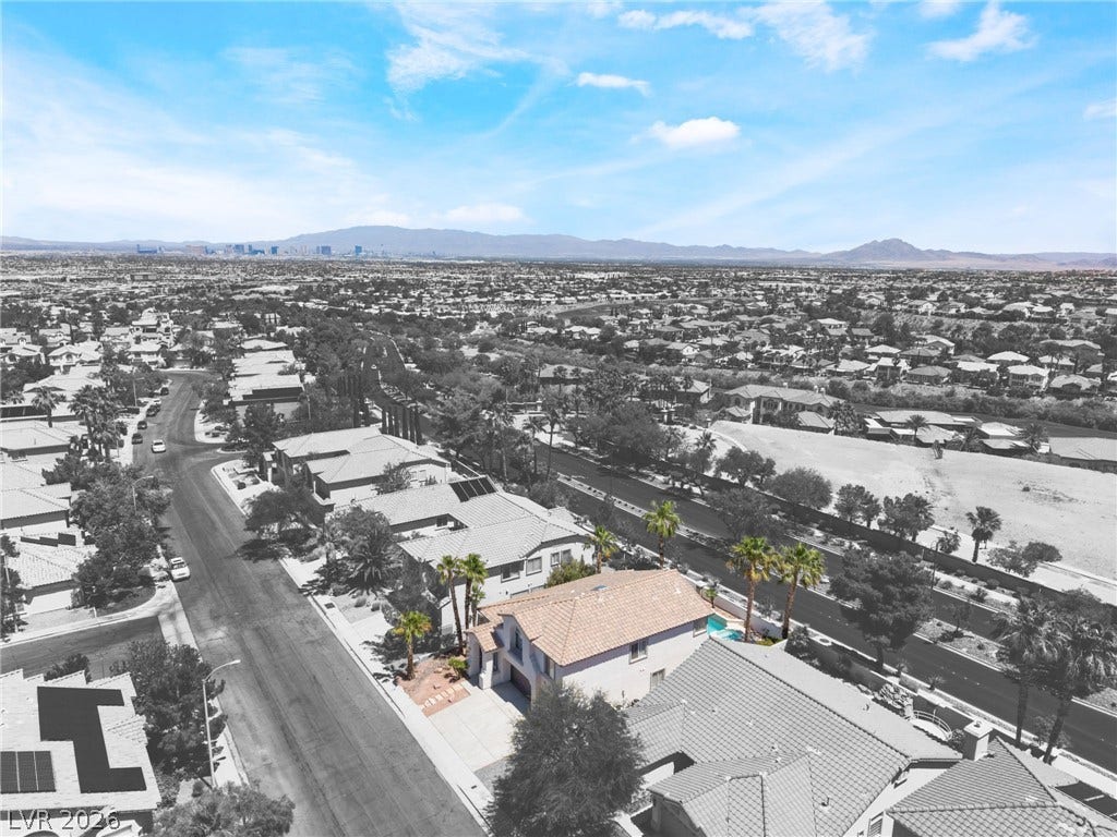 1278 Autumn Wind Way, Henderson, NV 89052 An aerial perspective reveals a residential neighborhood with distant city and mountain views.