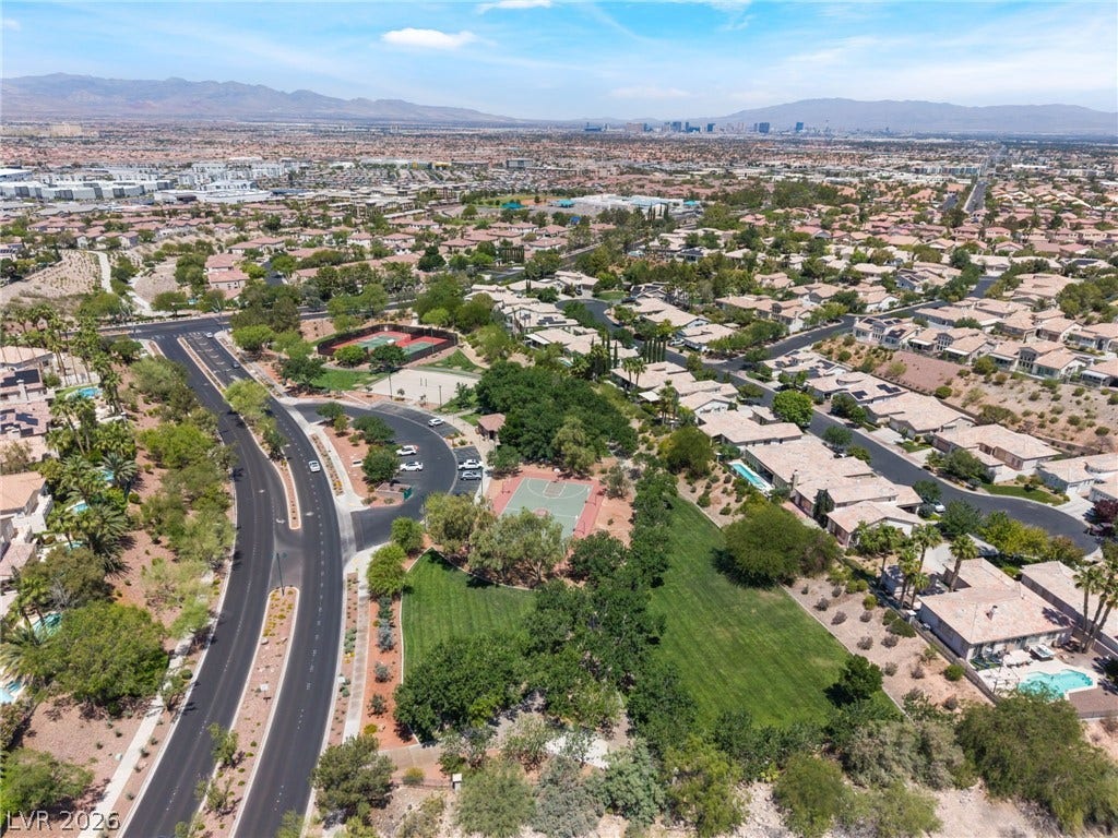 1278 Autumn Wind Way, Henderson, NV 89052 An aerial perspective reveals a vibrant community complete with residential homes, green spaces, and recreational courts.