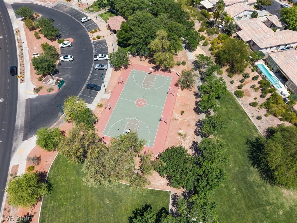 1278 Autumn Wind Way, Henderson, NV 89052 An aerial perspective reveals a vibrant community basketball court nestled amongst green lawns and mature trees.