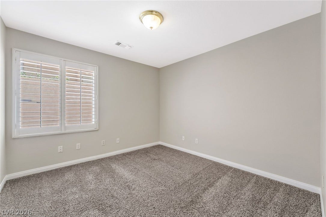 1278 Autumn Wind Way, Henderson, NV 89052 A well-proportioned room with plush carpeting and natural light filtering through the window shutters.
