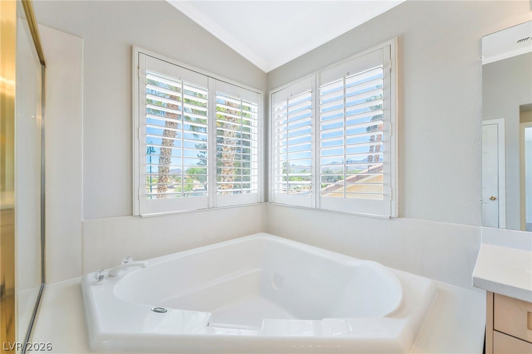 1278 Autumn Wind Way, Henderson, NV 89052 Corner tub with privacy shutters provides a serene retreat.