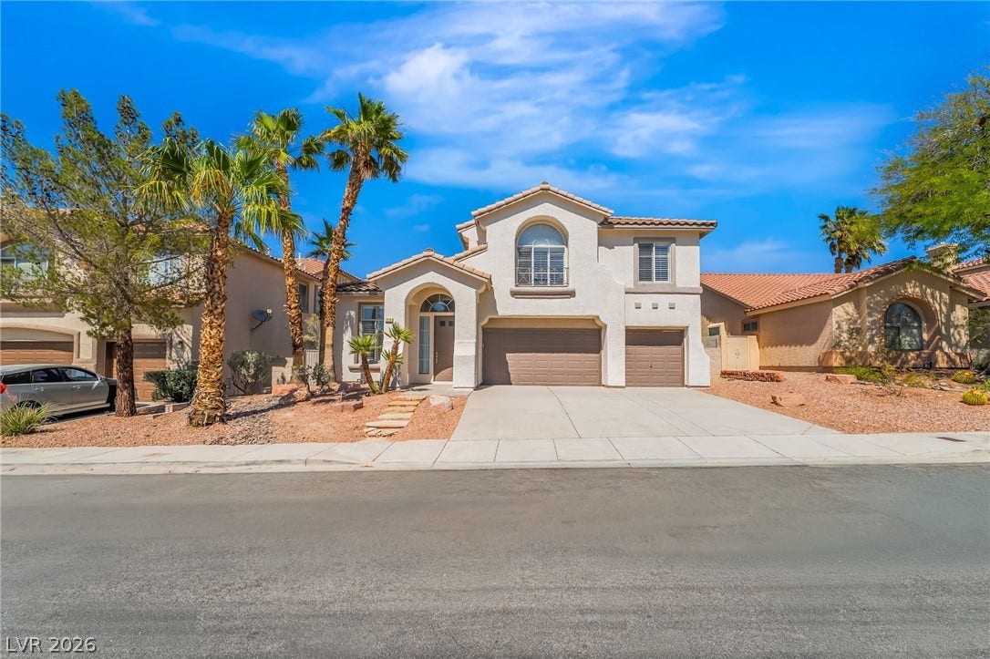 1278 Autumn Wind Way, Henderson, NV 89052 A well-kept residence presents a grand entrance with a double garage and mature desert landscaping.