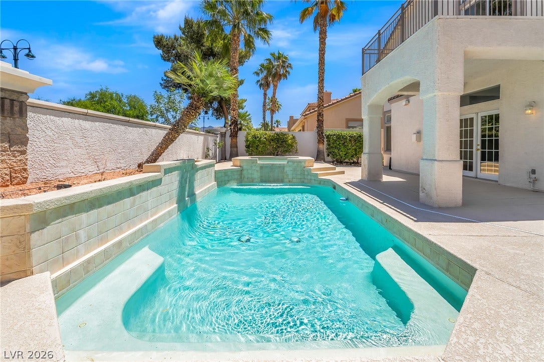 1278 Autumn Wind Way, Henderson, NV 89052 An inviting backyard oasis offers a sparkling in-ground pool, ideal for cooling off on warm days.