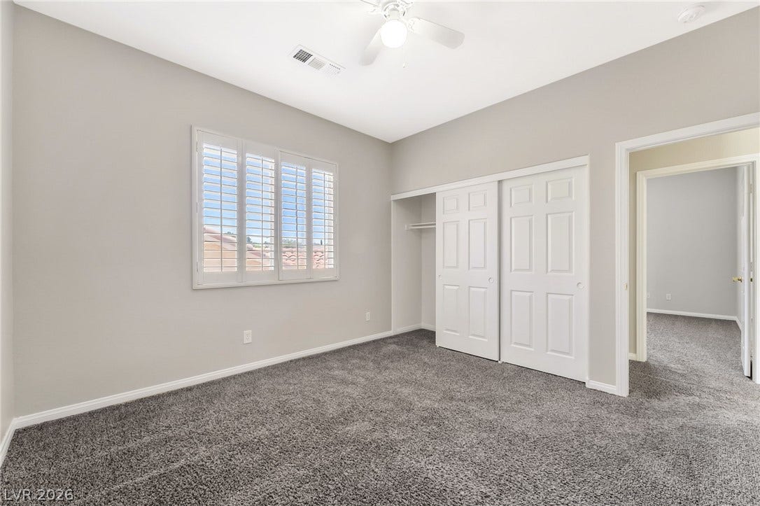 1278 Autumn Wind Way, Henderson, NV 89052 A well-lit bedroom features plush carpeting and practical closet space.