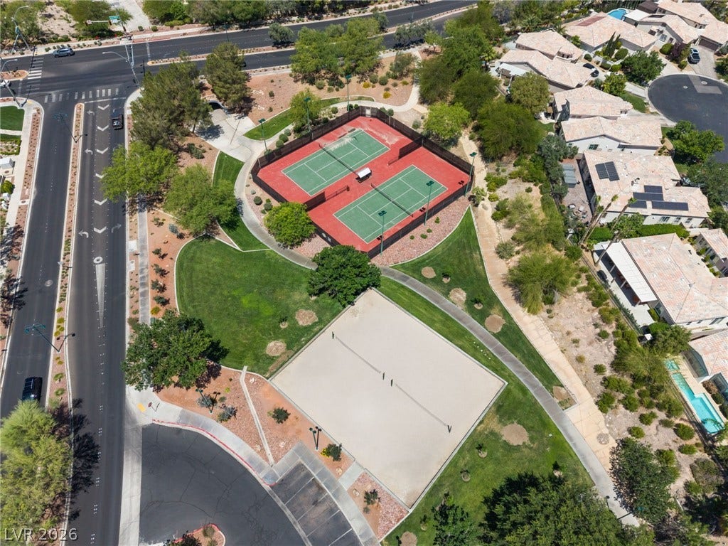 1278 Autumn Wind Way, Henderson, NV 89052 An aerial perspective reveals tennis courts, a sand volleyball court, and lush green spaces.