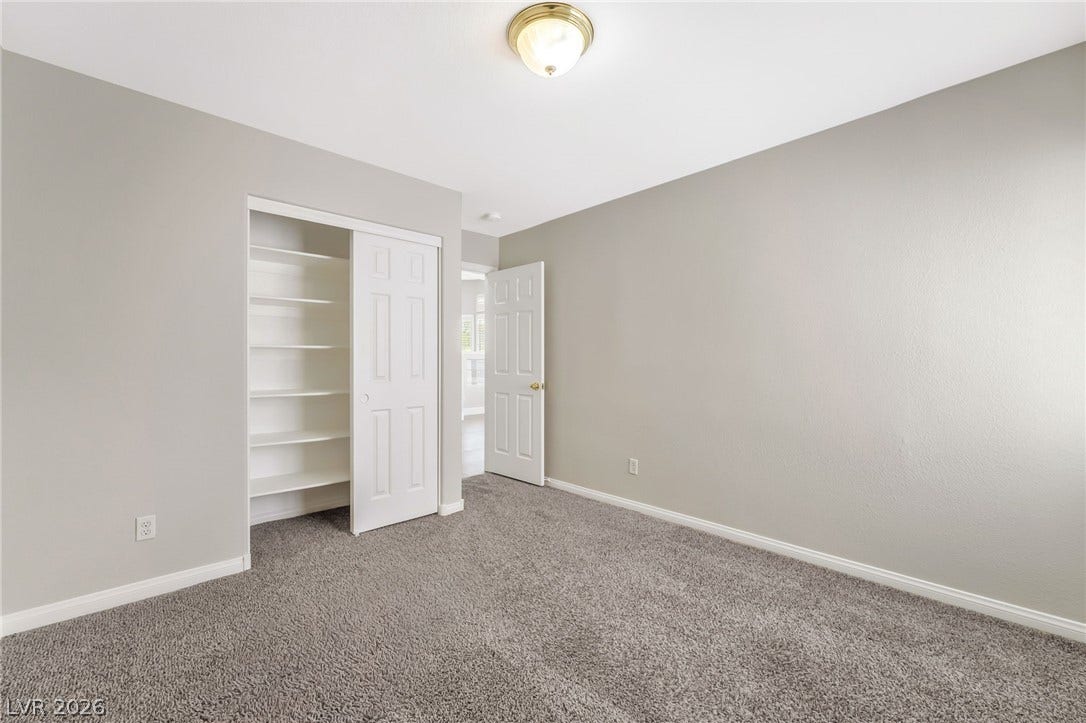1278 Autumn Wind Way, Henderson, NV 89052 A well-lit bedroom featuring a convenient built-in closet with ample shelving.