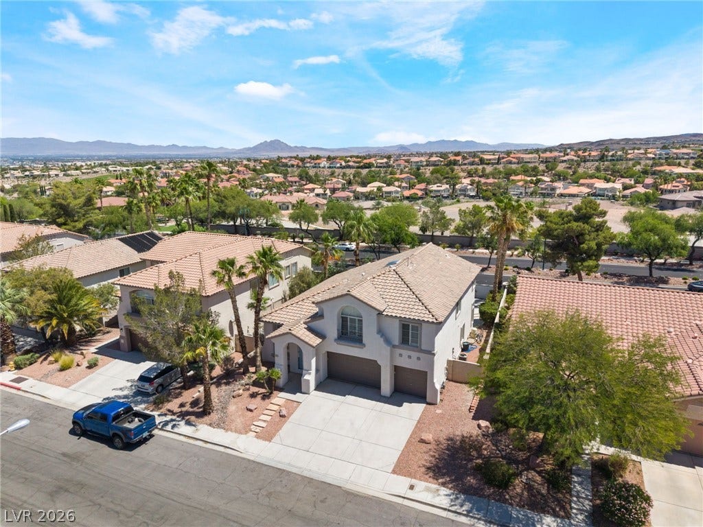 1278 Autumn Wind Way, Henderson, NV 89052 An aerial perspective reveals a desert community with a spacious two-story residence.