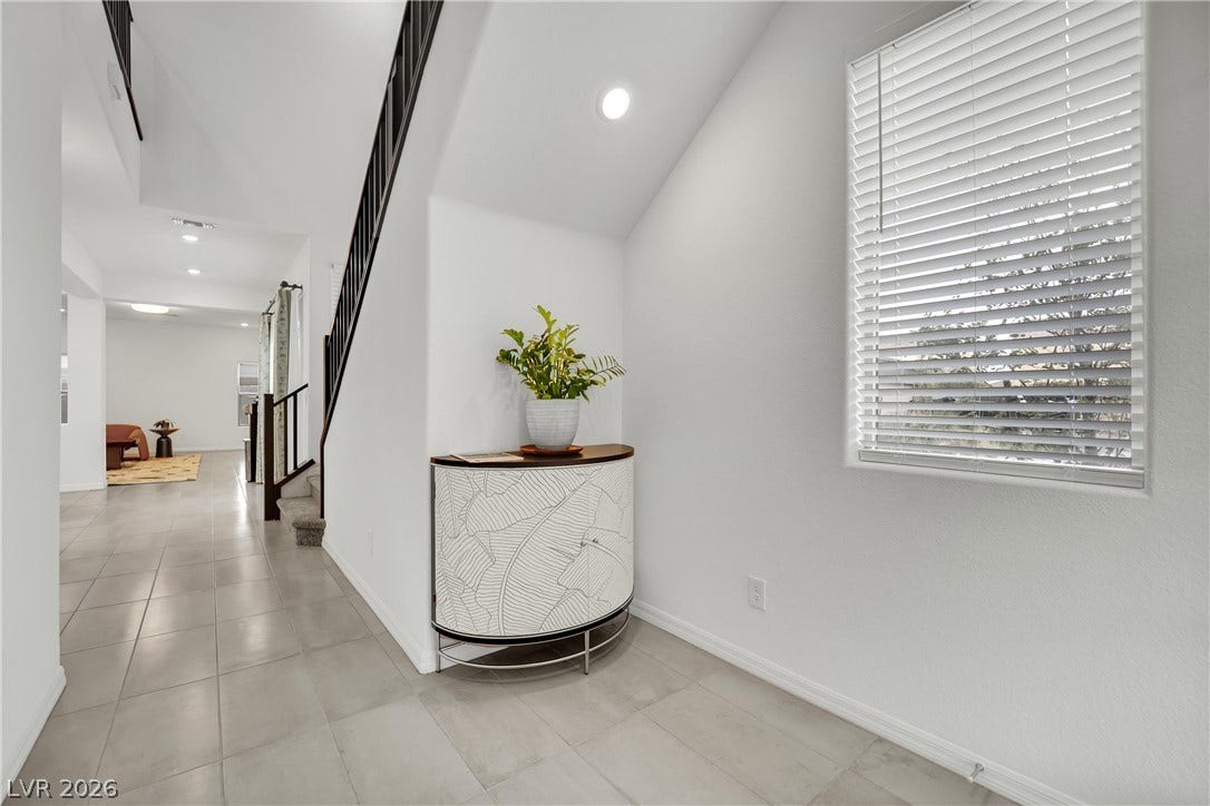 7710 Weekes Court, Las Vegas, NV 89113 Tiled floors and recessed lighting guide the way through this bright entrance foyer.