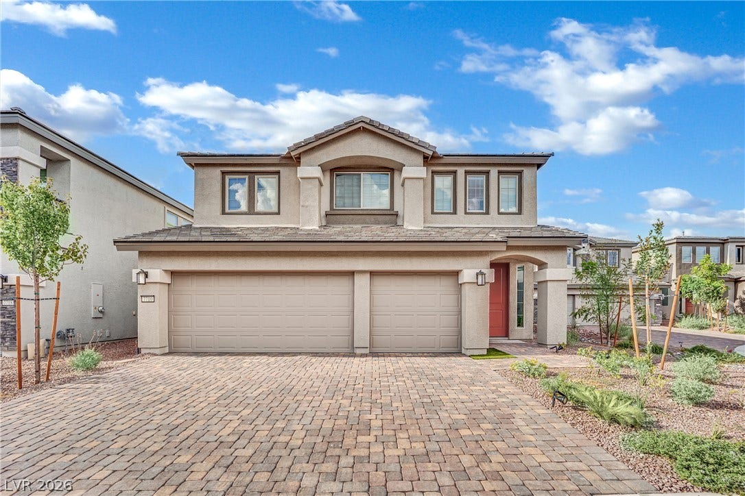 7710 Weekes Court, Las Vegas, NV 89113 An inviting paved driveway leads directly to the spacious three-car garage of this modern home.