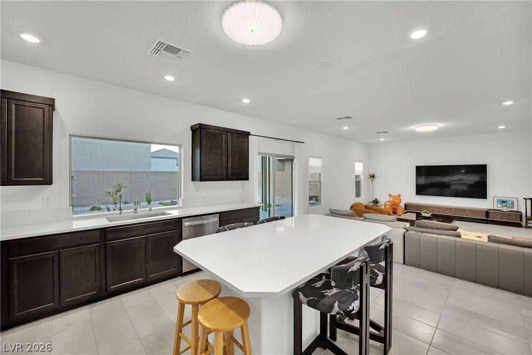 7710 Weekes Court, Las Vegas, NV 89113 Clean lines and smooth tile flooring define this modern open-concept space.