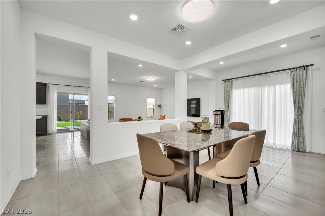 7710 Weekes Court, Las Vegas, NV 89113 Clean tile flooring and structured columns define this open-concept dining space.