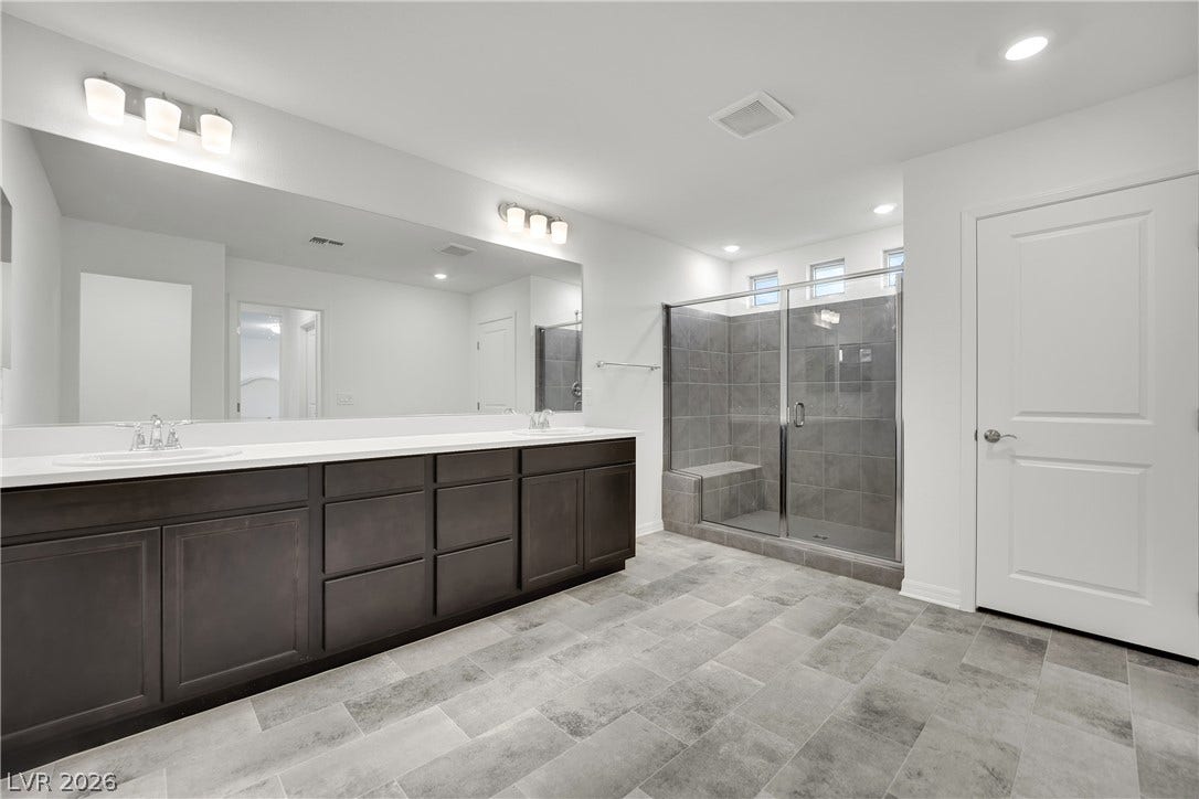 7710 Weekes Court, Las Vegas, NV 89113 Clean lines and a spacious tile shower define this modern primary bath.