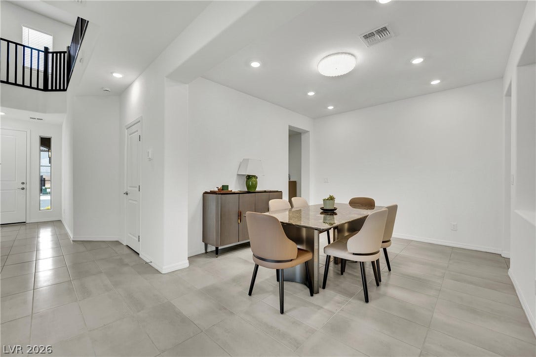 7710 Weekes Court, Las Vegas, NV 89113 Gleaming tile floors and clean white lines define this modern dining and entry space.