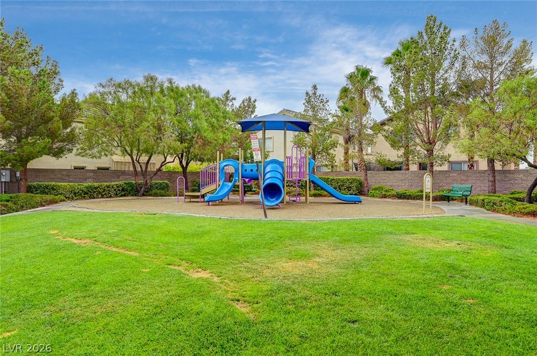 115 Cora Hills Court, Las Vegas, NV 89148 A vibrant playground structure and lush green space offer an inviting recreational area within the community.