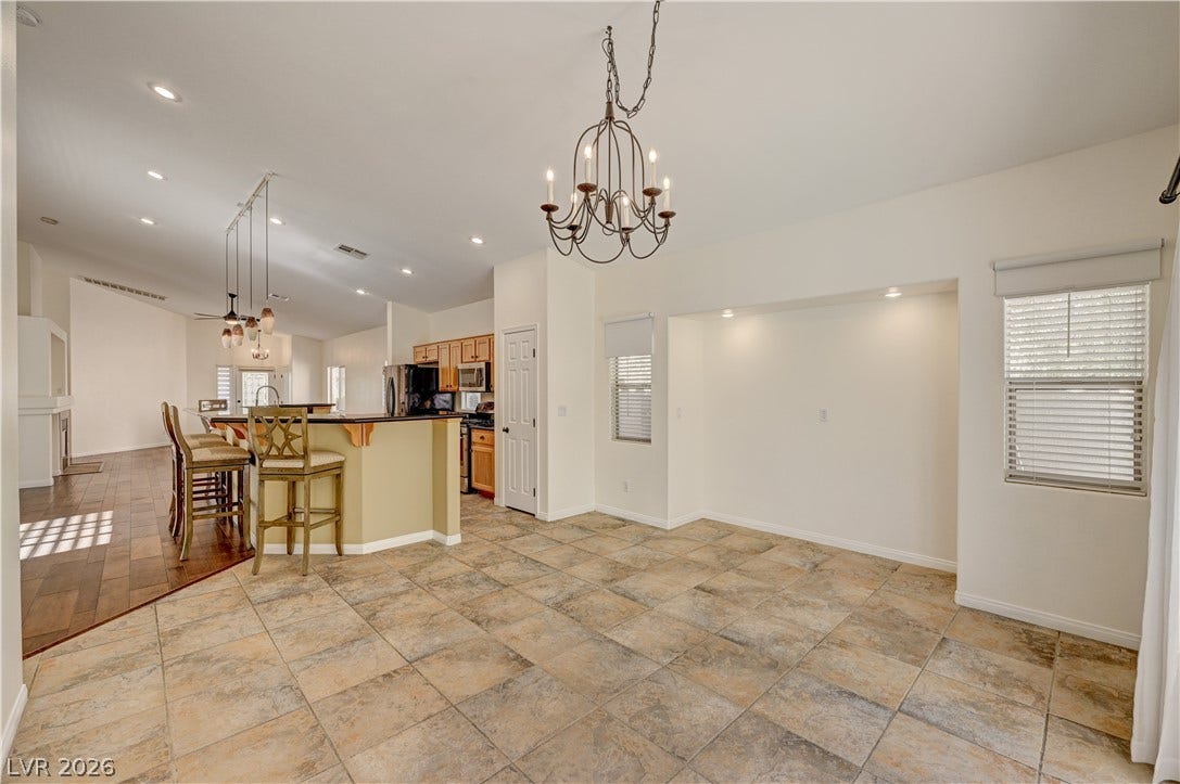 115 Cora Hills Court, Las Vegas, NV 89148 A versatile open-concept space featuring a breakfast bar, kitchen, and ample area for dining.