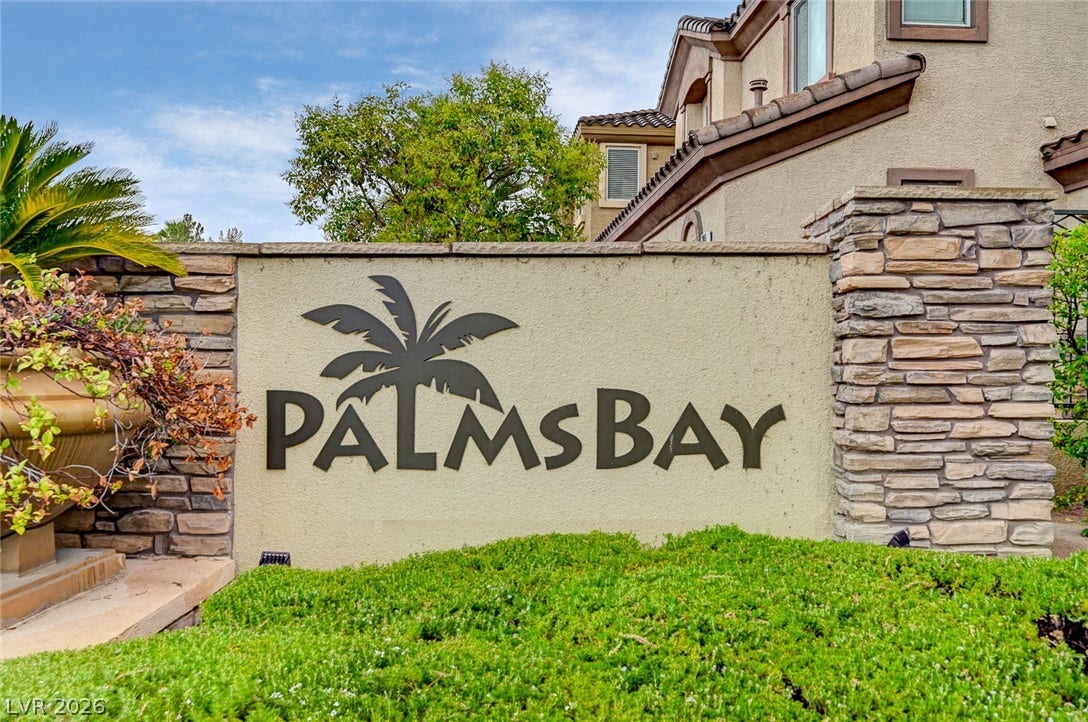 115 Cora Hills Court, Las Vegas, NV 89148 Welcoming community entry with natural stone accents and vibrant landscaping.