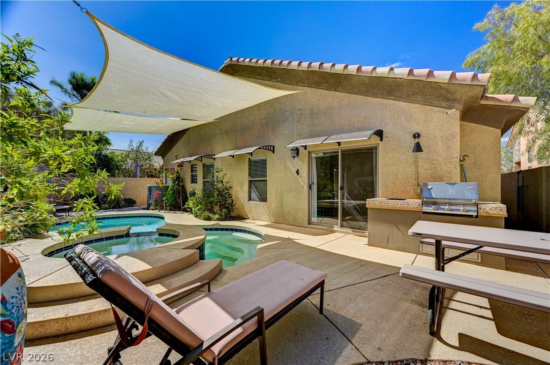 115 Cora Hills Court, Las Vegas, NV 89148 An inviting backyard oasis offers a sparkling pool and a built-in outdoor grill for entertaining.