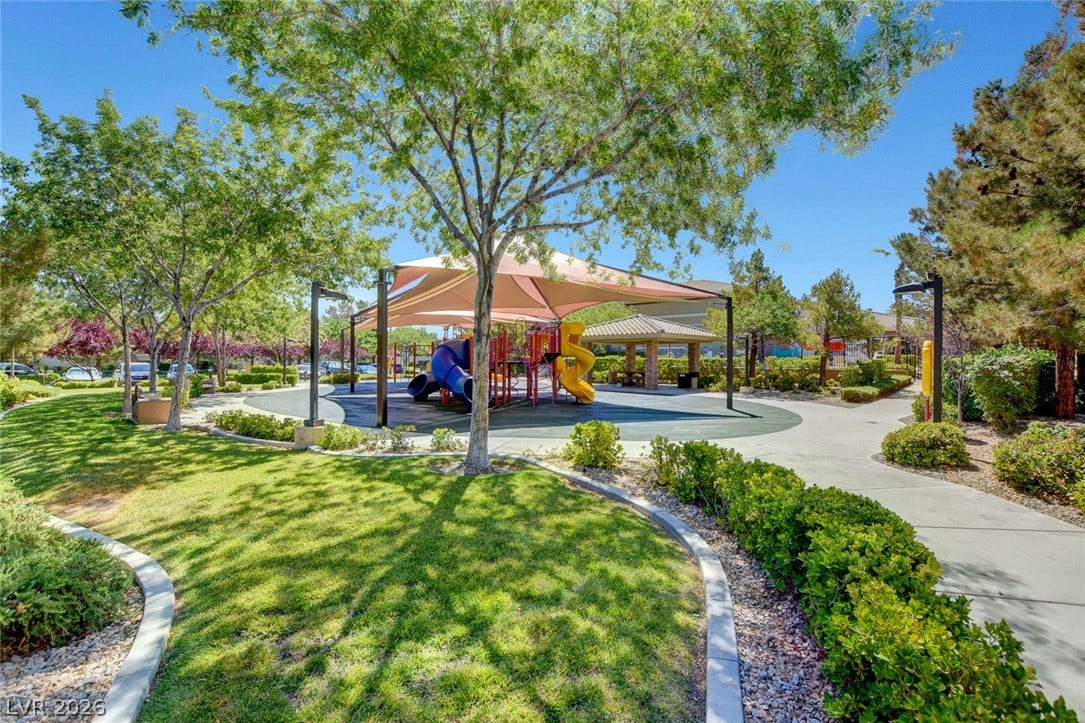 115 Cora Hills Court, Las Vegas, NV 89148 A well-maintained community playground offers shaded recreation with vibrant play structures and mature landscaping.