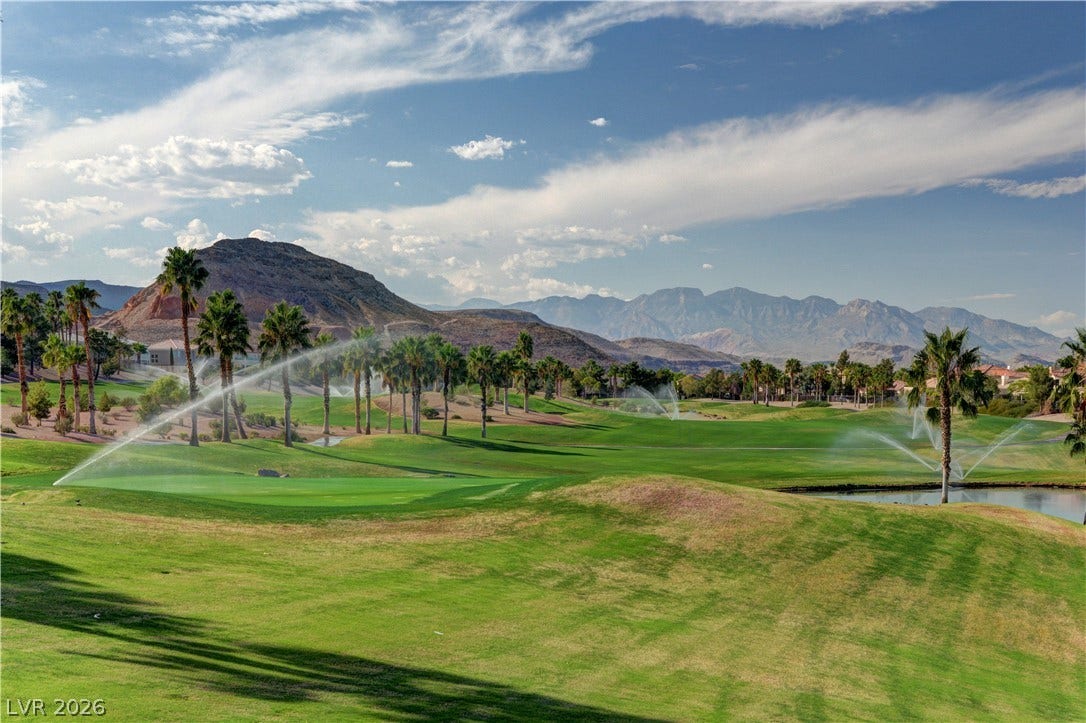 115 Cora Hills Court, Las Vegas, NV 89148 Green fairways and swaying palm trees offer a picturesque setting with mountain views.