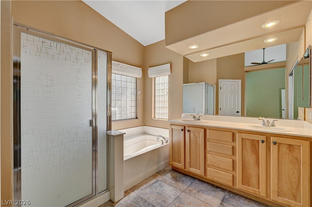 115 Cora Hills Court, Las Vegas, NV 89148 Indulge in a tranquil primary bathroom offering a separate shower and a soothing soaking tub.