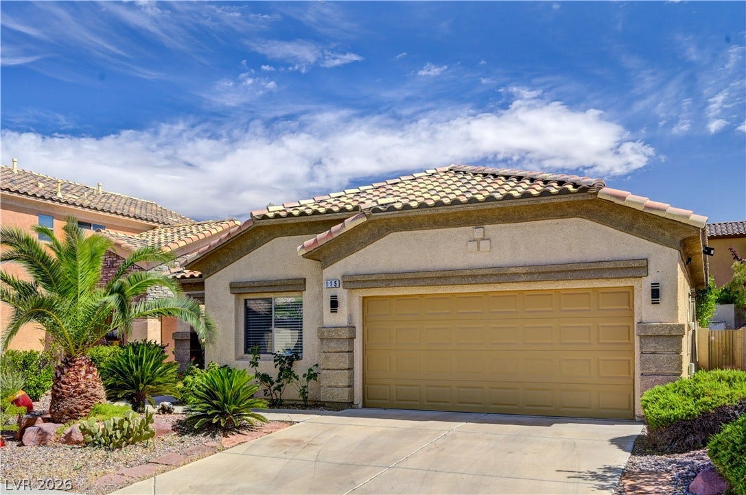115 Cora Hills Court, Las Vegas, NV 89148 A well-maintained desert landscape frames this single-story home with a tan garage door.