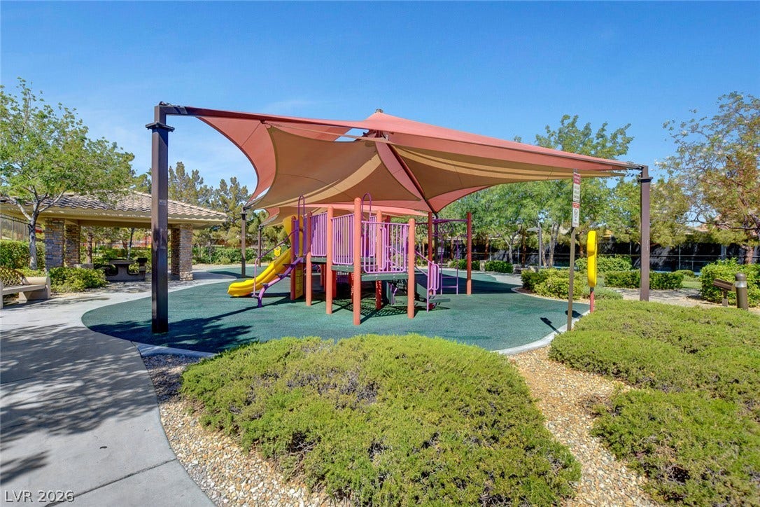 115 Cora Hills Court, Las Vegas, NV 89148 A vibrant playground with shade structures invites outdoor activity.