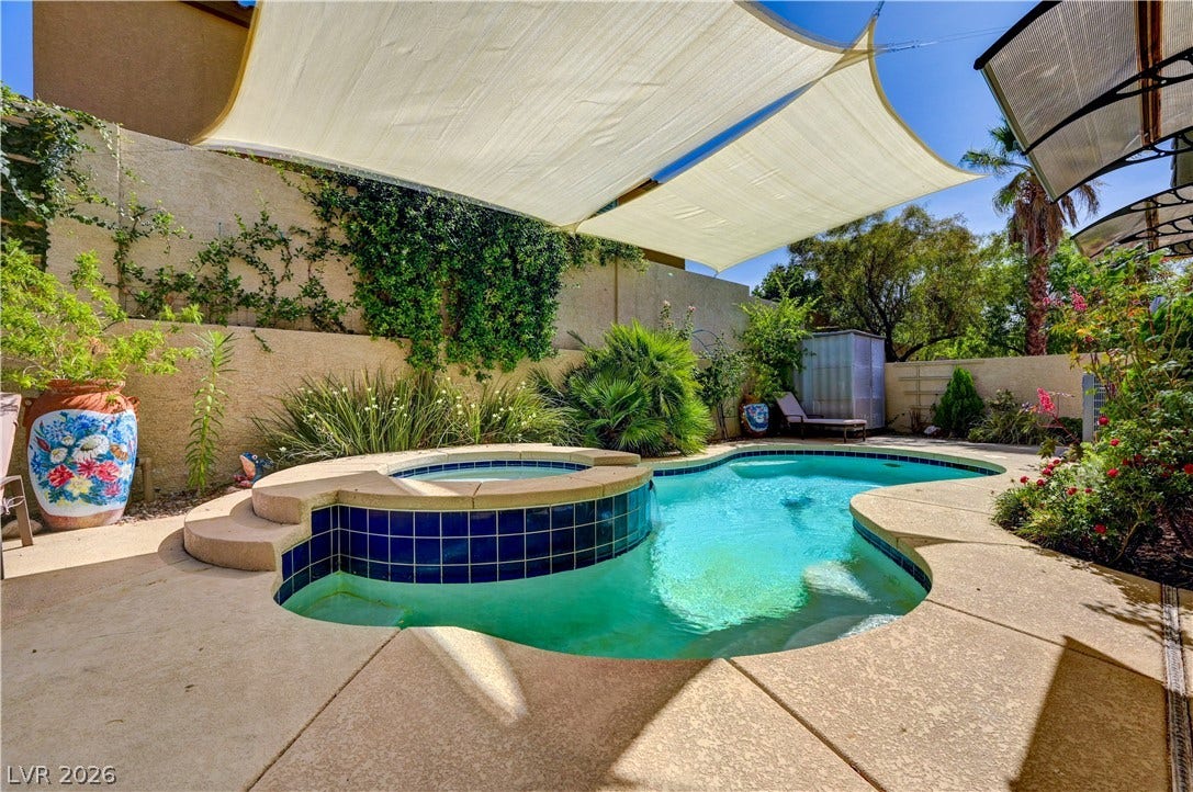 115 Cora Hills Court, Las Vegas, NV 89148 An inviting backyard oasis awaits with a sparkling pool and spa, perfect for relaxation and entertaining.