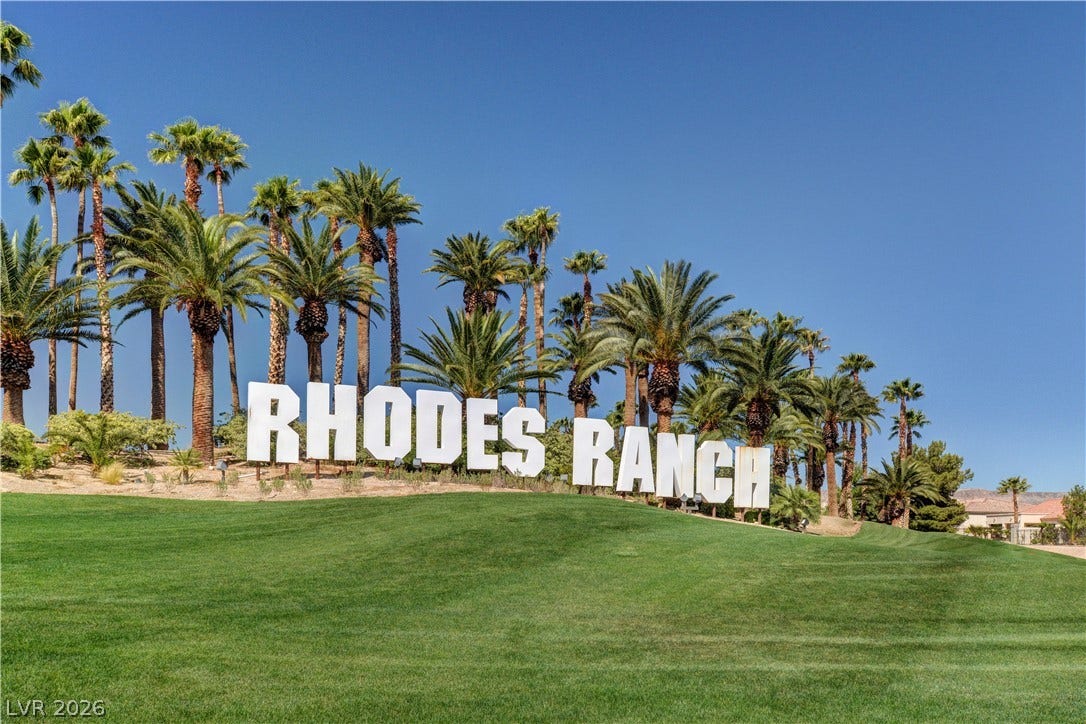 115 Cora Hills Court, Las Vegas, NV 89148 Rhodes Ranch welcomes you with lush greenery and towering palms under an azure sky.