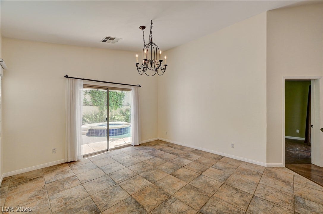 115 Cora Hills Court, Las Vegas, NV 89148 A sliding glass door opens to a private patio, extending the living space outdoors.
