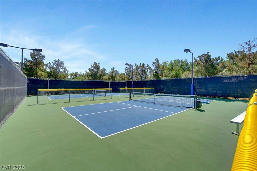 115 Cora Hills Court, Las Vegas, NV 89148 Sporting enthusiasts will adore this pristine outdoor pickleball court, ready for action under the clear blue sky.