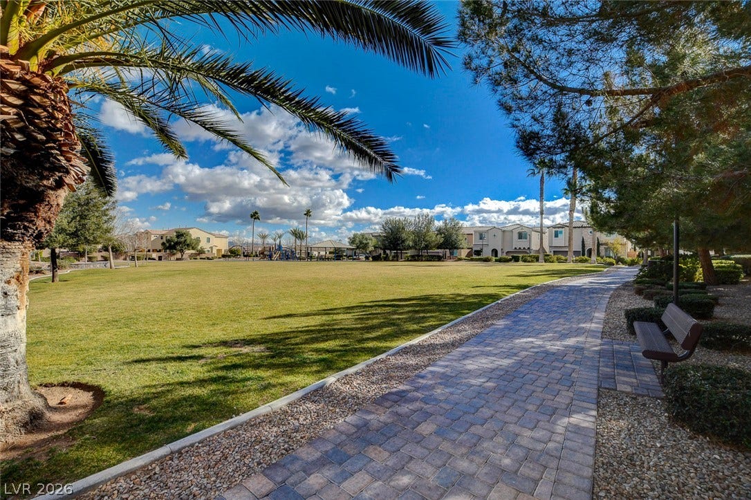 115 Cora Hills Court, Las Vegas, NV 89148 A well-maintained walking path winds through a verdant park, offering a peaceful community setting.