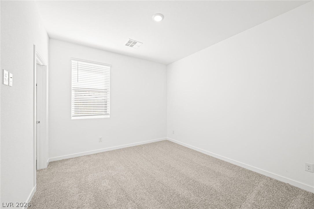 A well-lit bedroom provides a versatile space, ready for personalization.