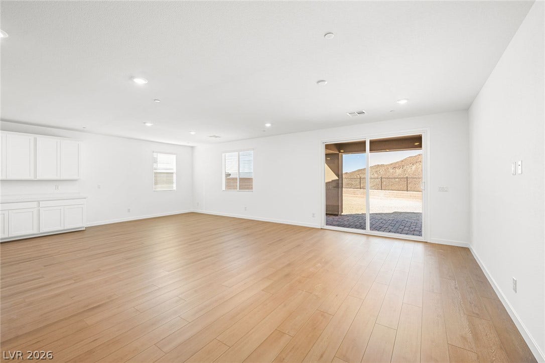 This naturally illuminated living space provides warm wood flooring and direct outdoor access.
