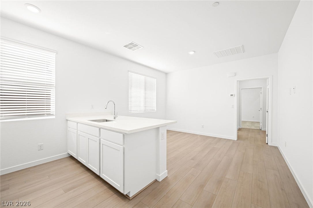 A streamlined kitchen island offers counter space and a built-in sink.