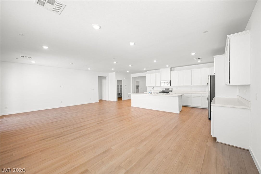 An open concept living area transitions seamlessly into a sleek kitchen, perfect for entertaining.