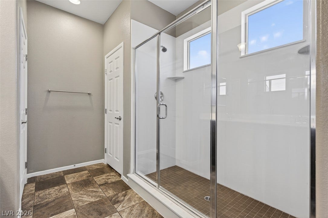 1146 Jesse Harbor Avenue, Henderson, NV 89014 A well-appointed shower space, complete with sleek glass enclosures and natural light.